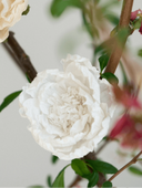 Handmade and hand-dyed crepe paper flowers in solid colors. Bouquets of paper flower Christmas ornaments in blue, white, and pale pink